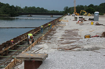 A sealed sheet pile cutoff wall at the canal on the south side of the CDF hydraulically isolates the groundwater at the site from the Lake George Branch of the Indiana Harbor and Canal. This photo shows the construction of the sealed sheet pile cutoff wall. 
