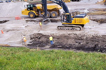 Perimeter cap excavation along dike toe for chimney drain construction.