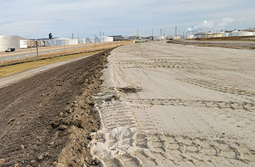 Topsoil placed on fully widened dike slope up to the level of the existing dike.